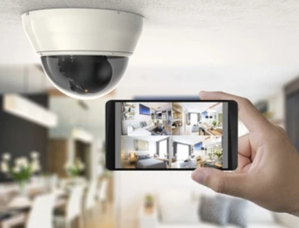 a phone in a living room with a camera mounted on the ceiling